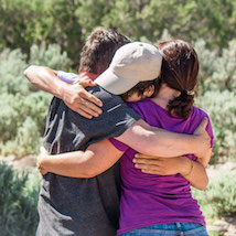 Group of teens embracing in hug