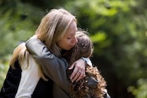 Woman and student hugging