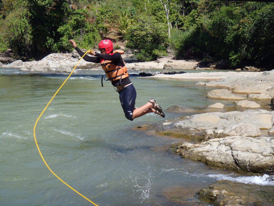 student jumping into costa rican water