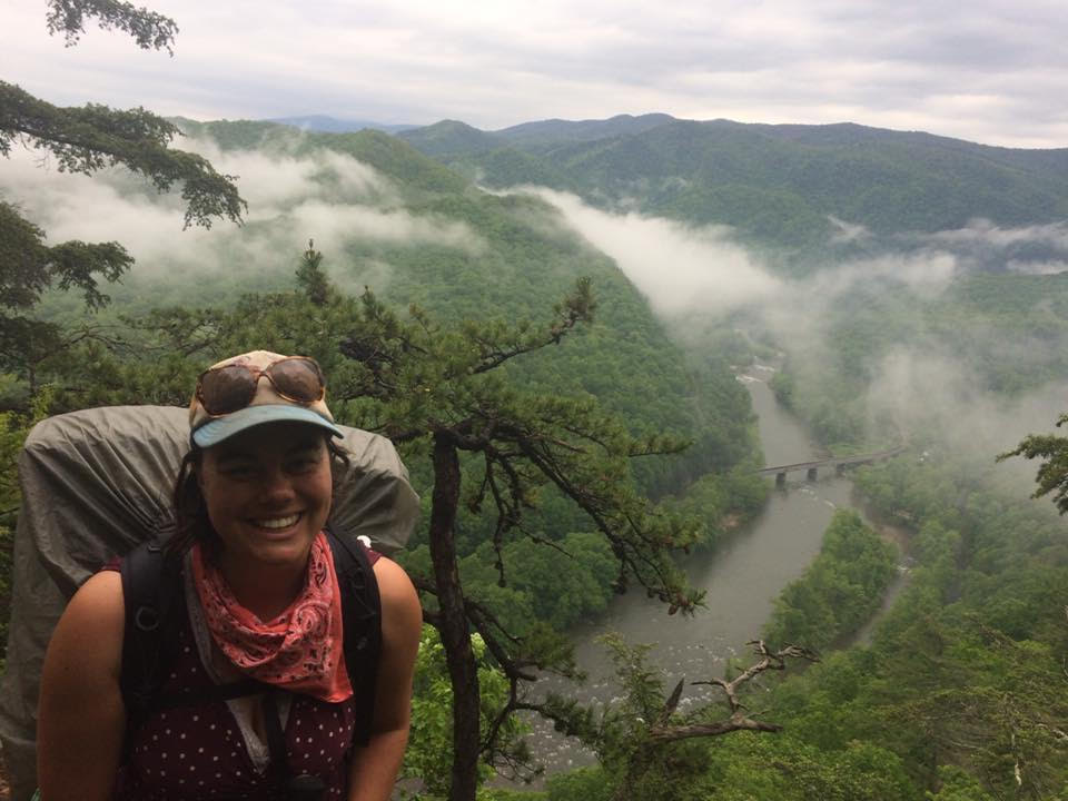 Micaela Cypher hiking with a backpack
