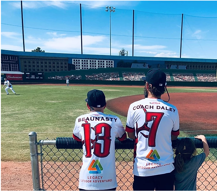 Two softball players watching a game in progress