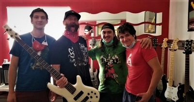 Photo of Chris Kael, bassist for Five Finger Death Punch, and three clients.