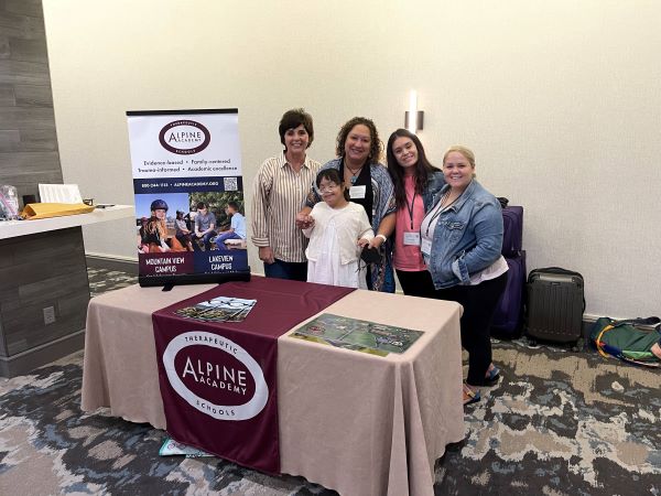 photo of the therapists who attended the ATTCh conference and table display.